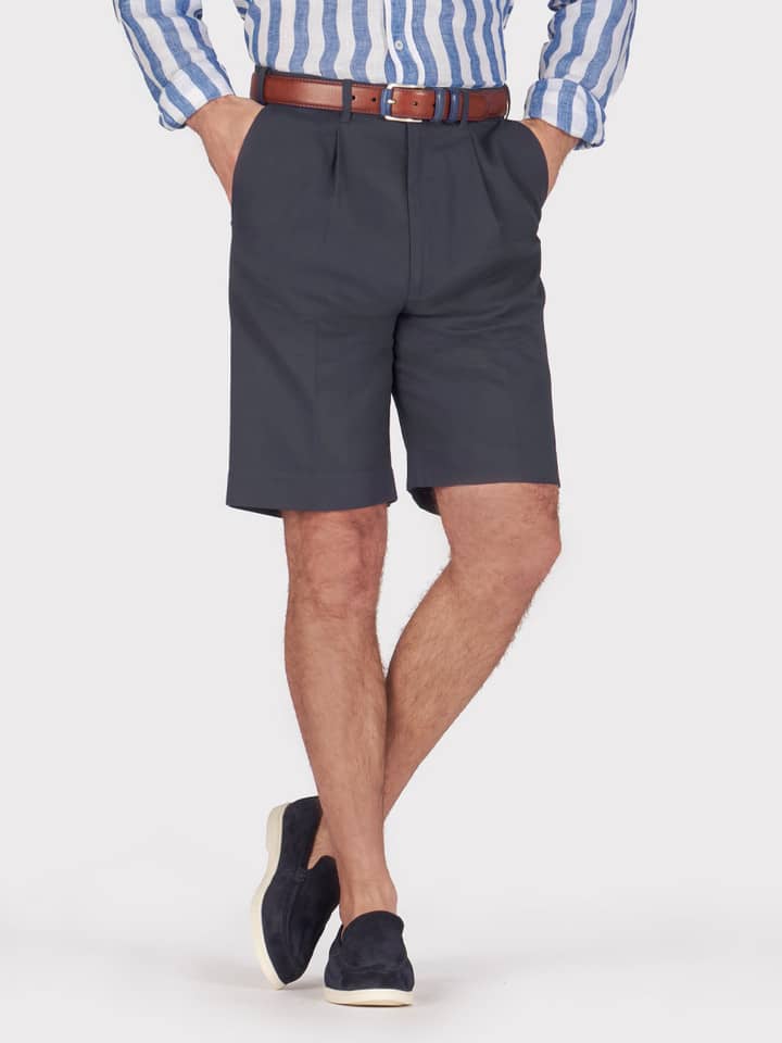 Model wears Men's Navy Blue Cotton Pleated Chino Shorts